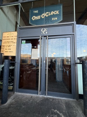 Grey glass doors. Long metal handle in middle. Push to open.