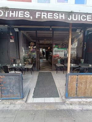 From street, facing venue. Opening to outdoor area ahead.