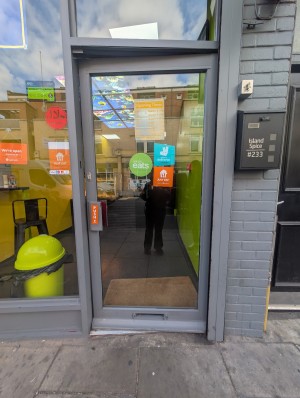 Grey frame door in front. Grey handle on left. Push to open.