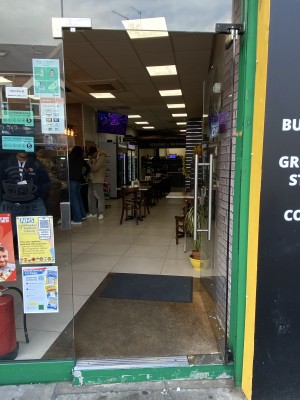 Glass door with silver metal handle on left side. Push from left to open.