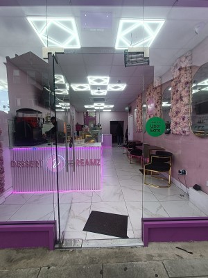 Glass door with silver handle on right. Push to open.