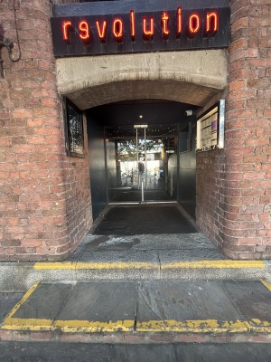 Archway with steps heading to door.