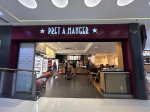 From mall corridor facing venue. Opening to venue ahead. Condiments station on right.
