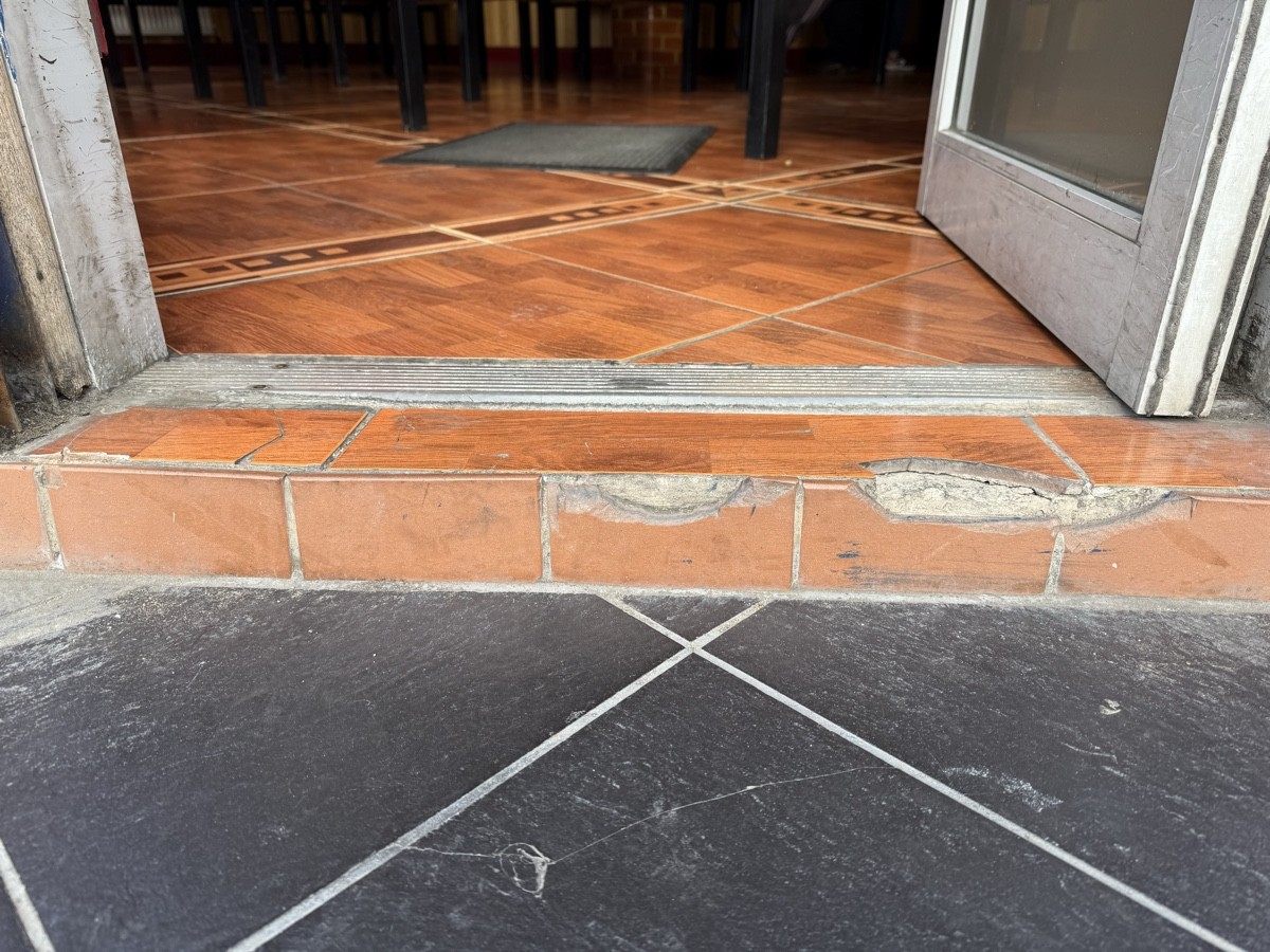 Step up at foot of door followed by bump.