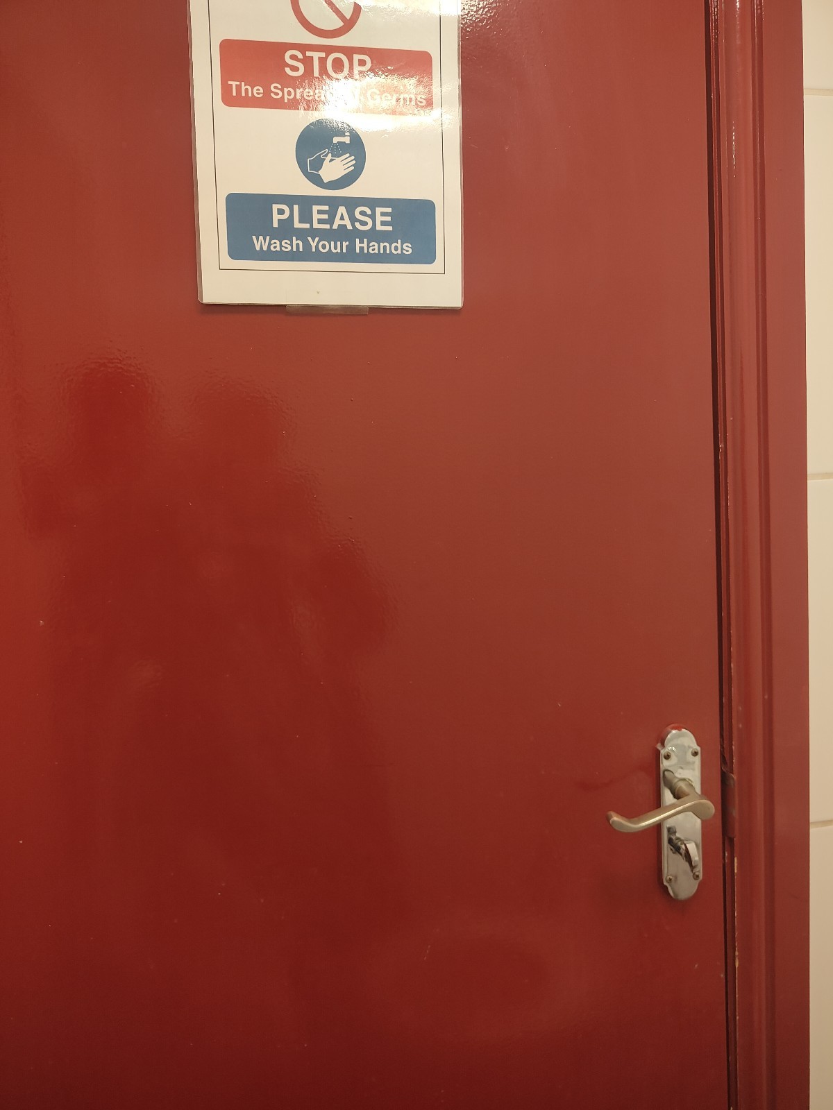 Back of door. Pull steel handle on right to open.