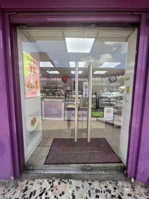 Glass double door with a purple frame. Handles in centre, push to open.