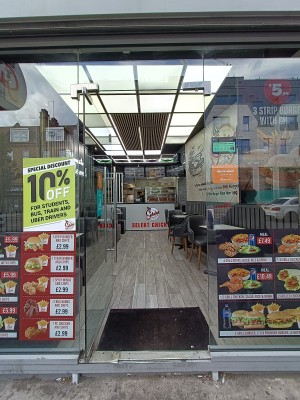 Glass door with silver handle on right. Push to open.