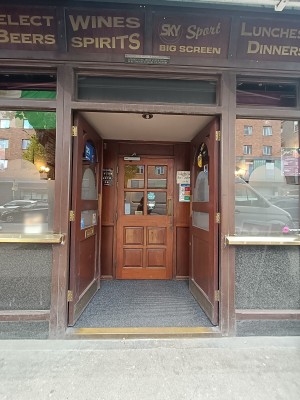 Glass door with brown, wooden frame. Push from middle to open.