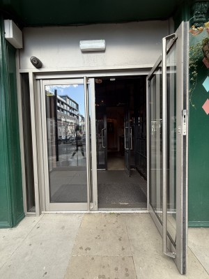 Grey glass doors. Pull to open. Metal handles in centre.