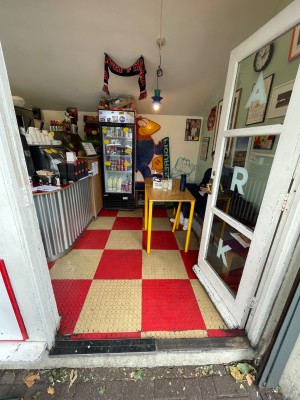 White framed glass door. Push golden handle on left to open.