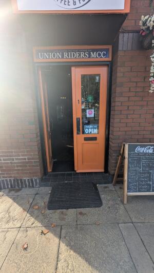 Glass doors with orange frames. Push in center to open
