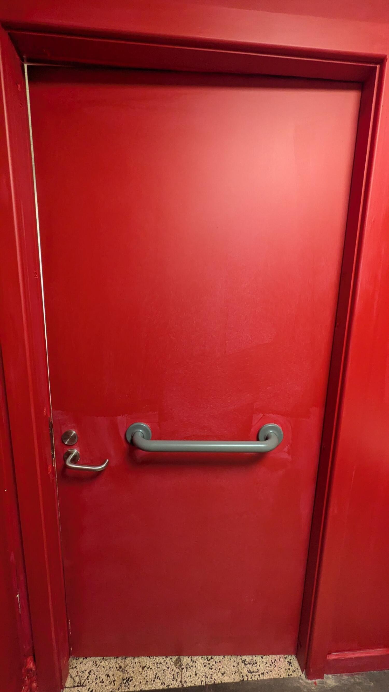 Back of toilet door. Lock on left. Grab rail in center.