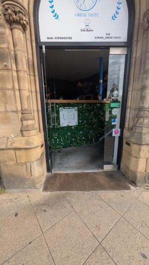 Glass door. Push metal handle on right to open.