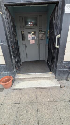 Black wooden doors. Push handles in center to open