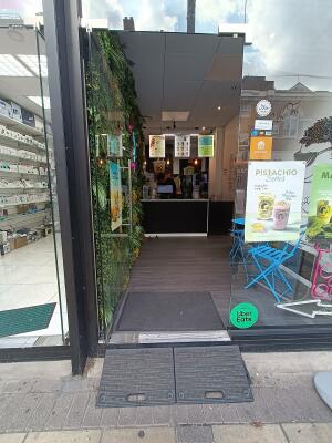 Glass door with silver handle on right. Push to open.