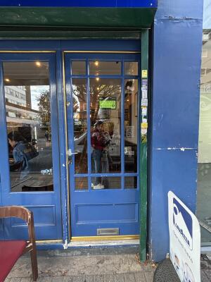 Blue door with glass windows, door handle to the left, push to open