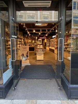 Black framed glass door. Silver metal handles in centre. Pull to open.