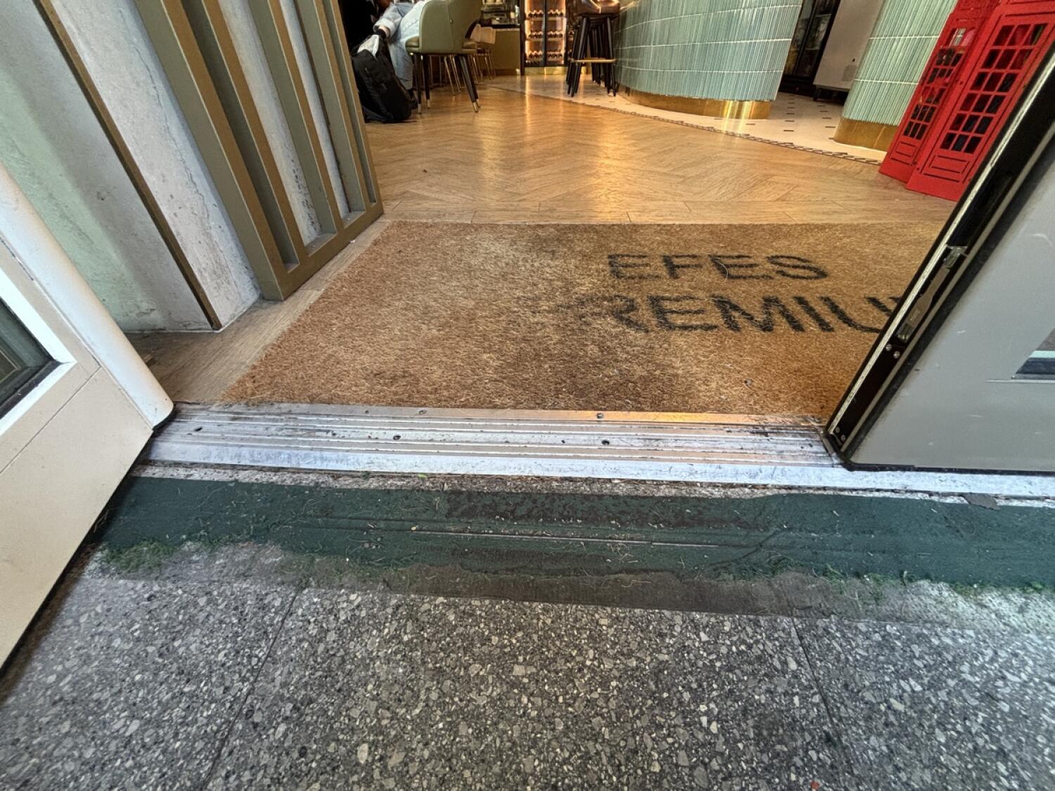 Small bump at foot of door followed by doormat.