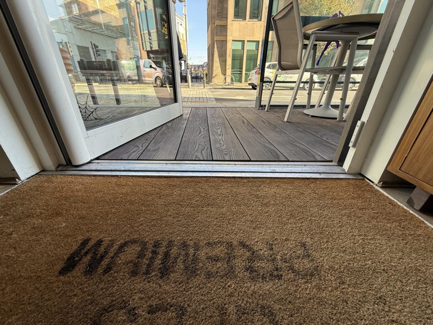 Doormat before door, small bump at foot of door.