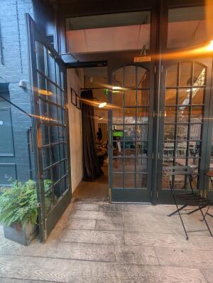 Grey frame door in front. Gold metal handle in middle. Pull to open