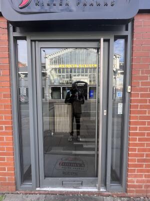 Glass door with handle on right. Push to open.