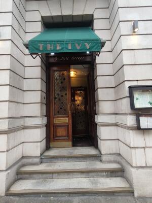 Three steps to venue in front. Wooden framed double glass doors ahead. Push golden handle in centre to open.