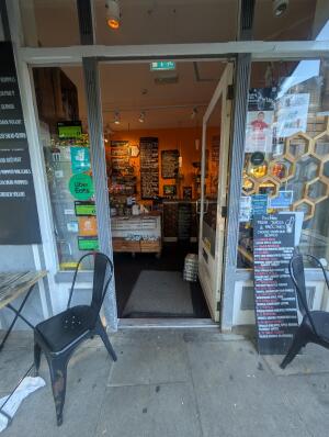 White frame glass doors in front. Metal handle on left. Push to open.