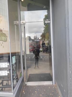 Glass door ahead. Push steel handle on left to open.