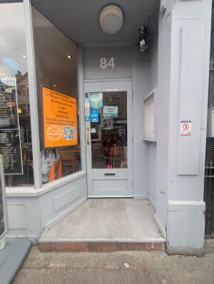 Grey archway in front. Grey frame glass door at back. Gold handle on left. Pull to open.