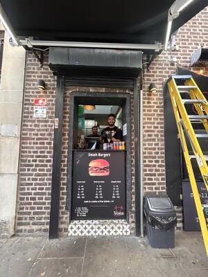 Black framed kiosk with one step in front and high counter.