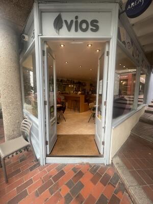 Glass doors with grey frame ahead. Push handle from centre to open.