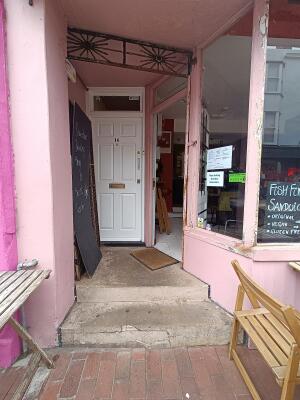 From street, facing venue. Opening ahead to doorway.