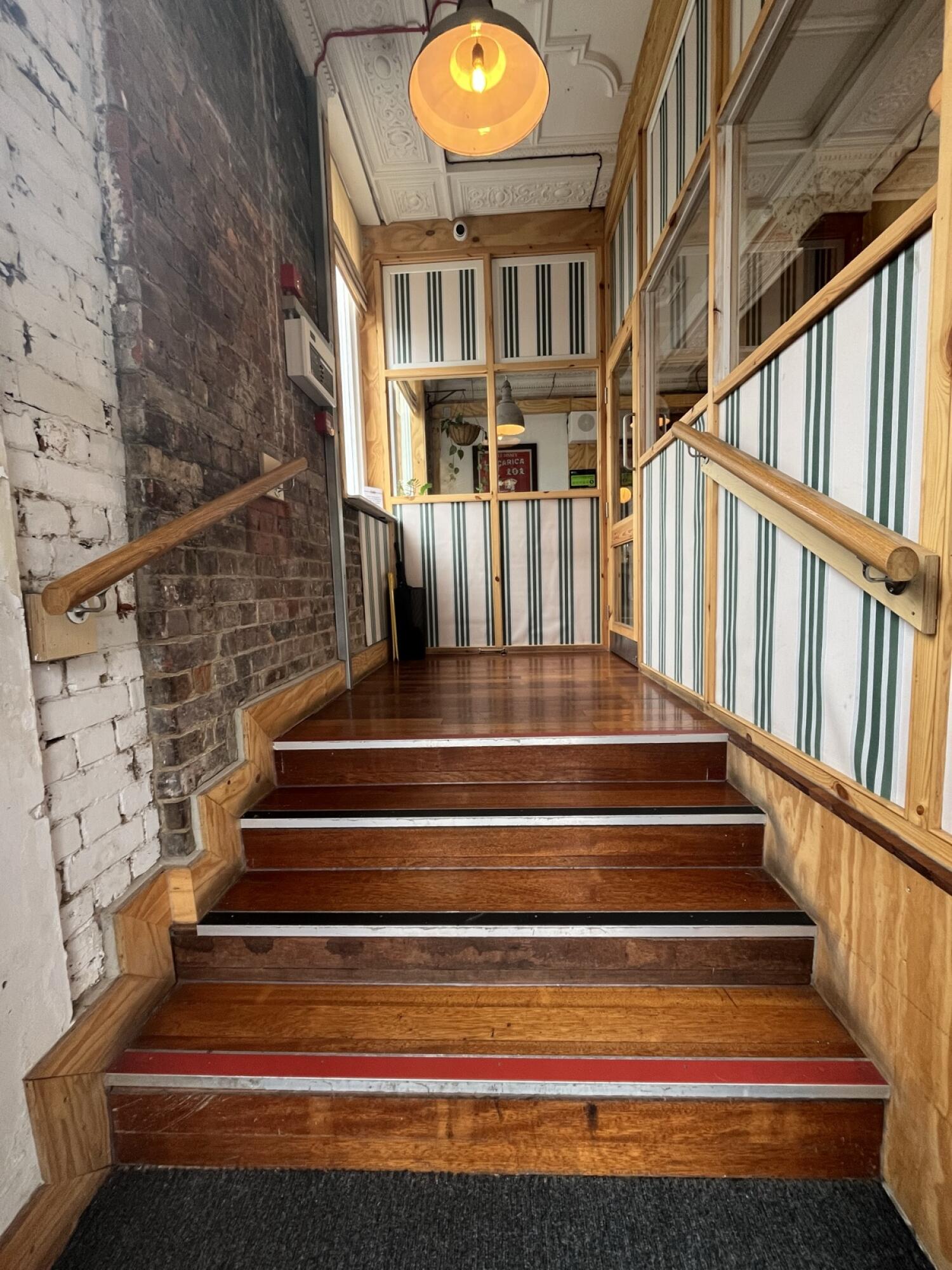 From door facing straight. Stairs ahead with handrails on both sides.