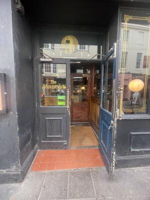 Glass and wooden doors ahead. Pull gold metal handles from centre to open.