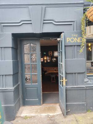 Grey framed frosted glass doors. Pull golden handles in centre to open.