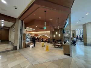 From mall lift facing straight. Entrance to venue ahead.