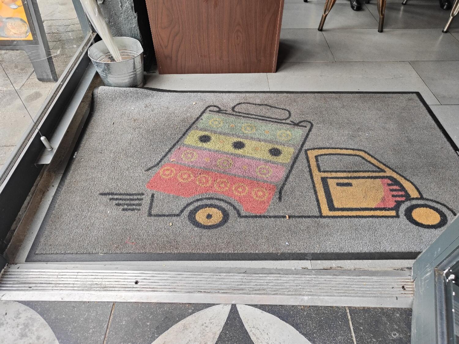 Metal ridge at door threshold. Doormat after.