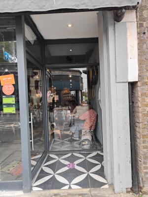 From street facing venue. Archway to venue door. Entrance door on the left.