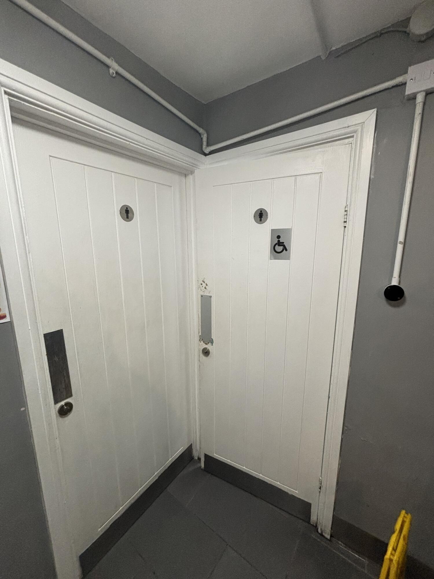 From entrance facing slightly right. Door to accessible toilet on right. Pull door to open.