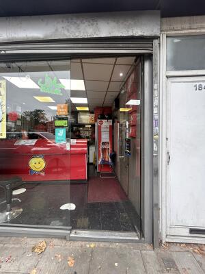 Glass door with glass frames ahead. Push metal bar on left to open.