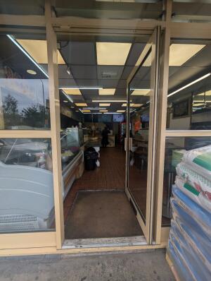 Beige frame glass doors in front. Handle on left. Push to open.