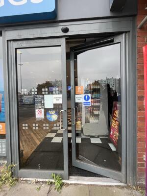 Glass double door with handle on centre. Push to open.