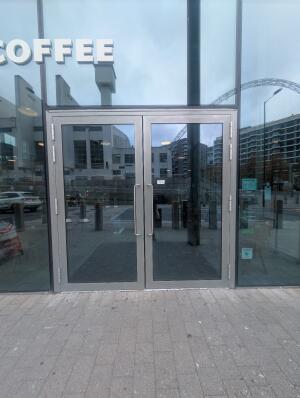 Grey frame glass double doors in front. Silver handles in middle. Pull to open.