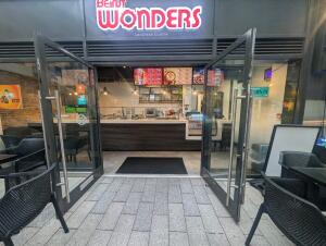 Grey frame glass doors in front. Metal handle along center. Pull to open.