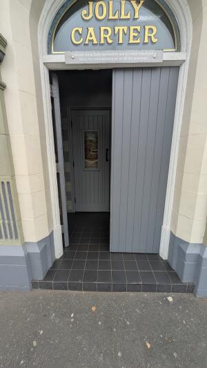 Grey wooden doors. Push handle in center to open