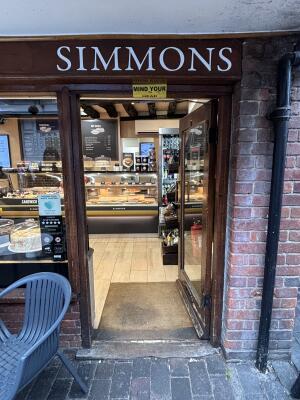 Glass door with wooden frame ahead. Push from left to open.