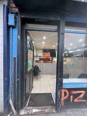 Black wooden door with handle on right. Push to open.