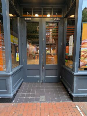 Double grey doors with one handle on right door. Pull to open.
