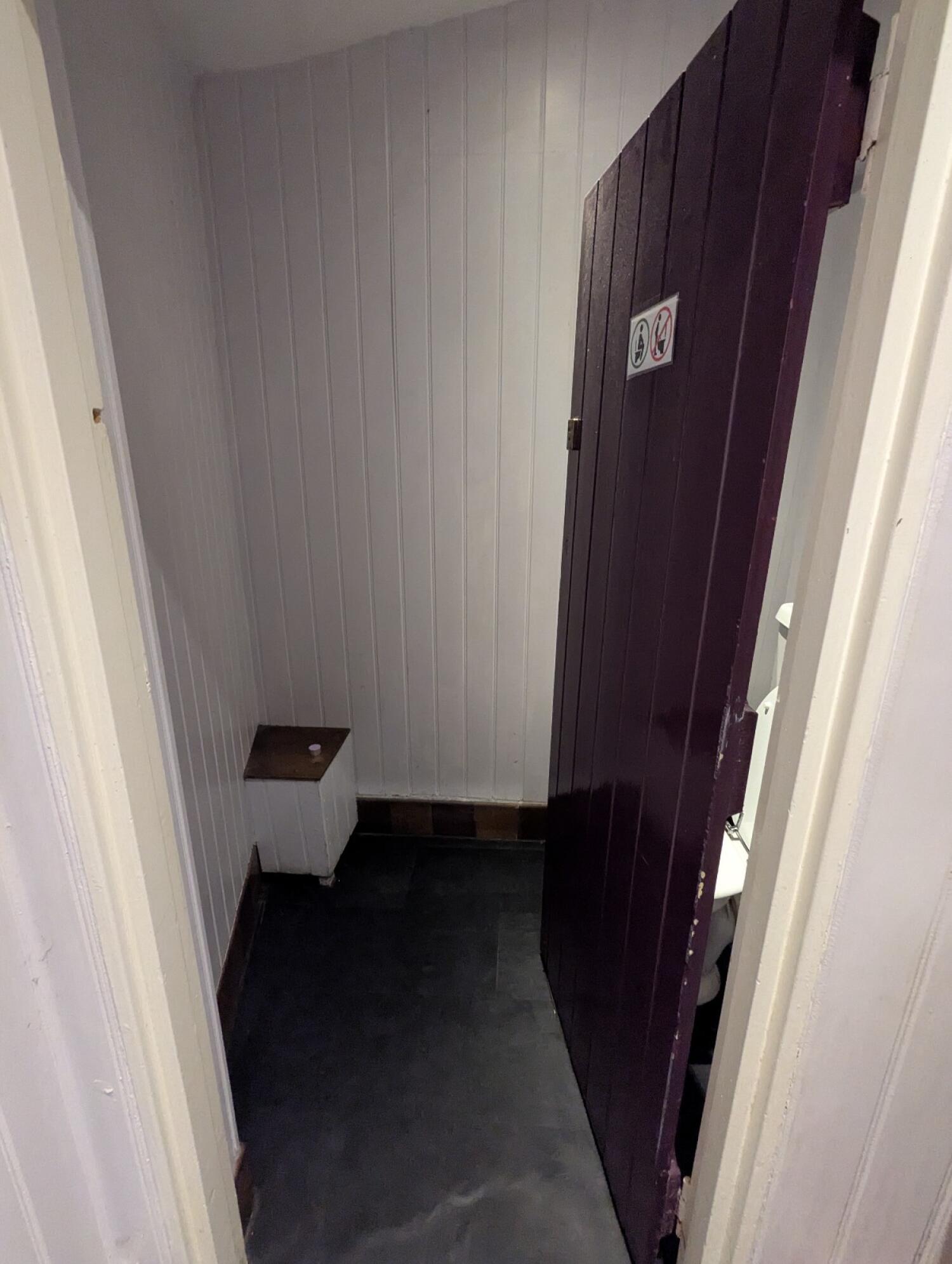 From sink looking ahead purple door.  Push from left to open.