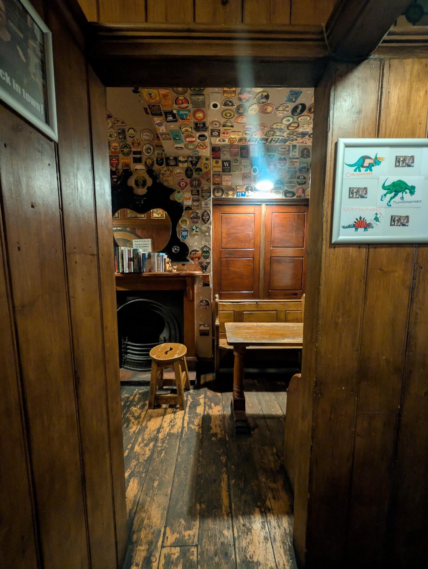 From left of chair facing left. Wooden archway in front. Seating behind.